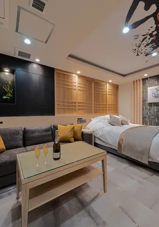 壁画が特徴的な和モダンな客室。手前のテーブルにはシャンパンが用意されている