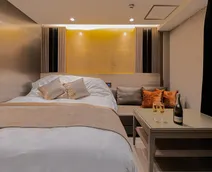 金色の壁が輝くベッドルーム。手前にはベッドとシャンパンが置かれたローテーブル